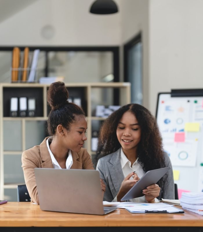 two-young-business-people-working-together-in-office-financial-analysis-accounting-concept-.jpg